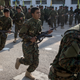 Syrian Democratic Forces (SDF) fighters perform in a parade march during a SDF victory ceremony announcing the defeat of ISIL in Baghouz held at Omer Oil Field on March 23, 2019 in Deir Al Zor, Syria.